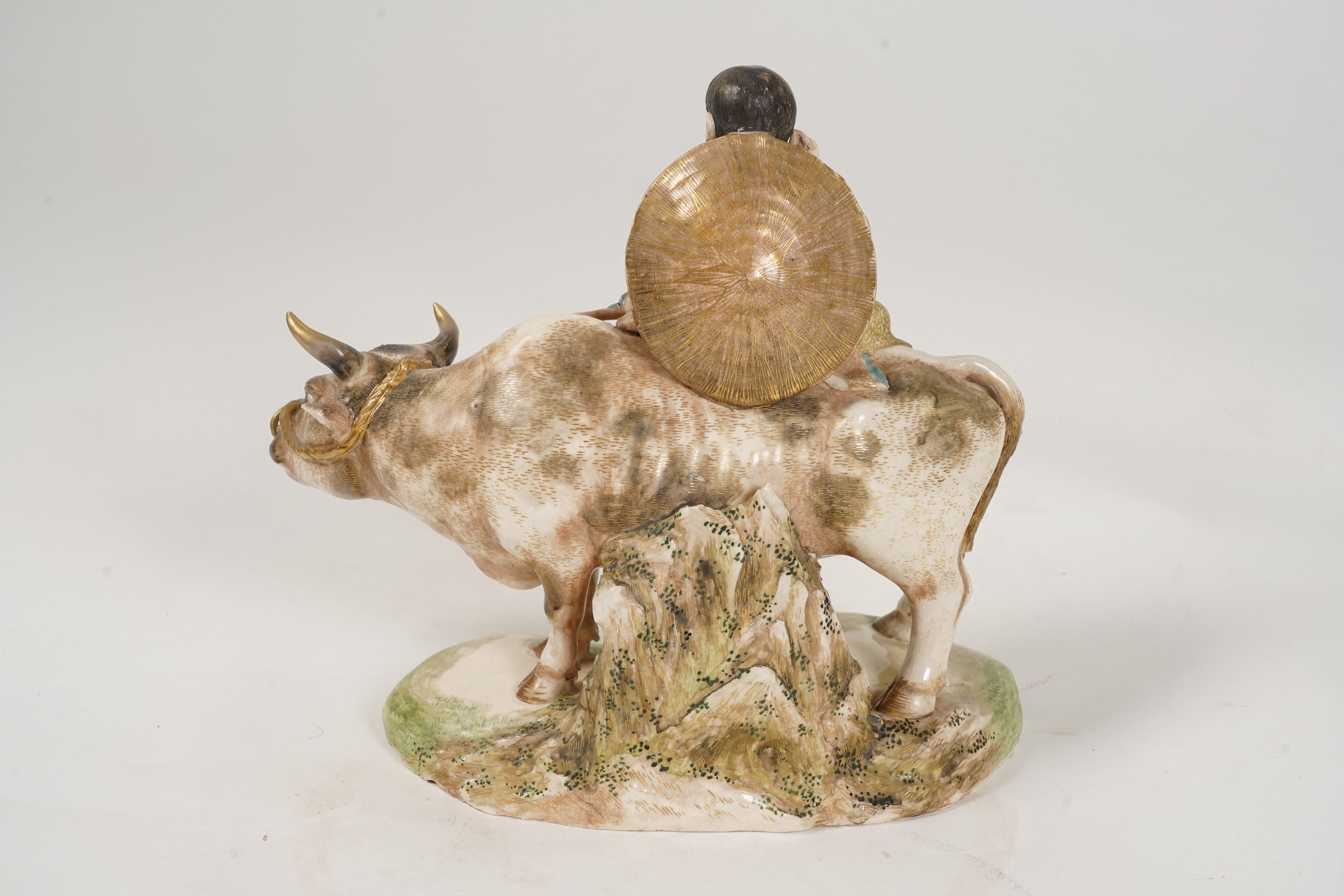 A large Japanese Satsuma model of boy riding on a buffalo, signed Hozan, Meiji period
